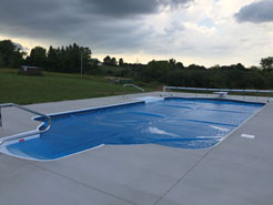 Shown Waide’s Pools and Spas completed pool installation.  Pool is covered with solar heater.